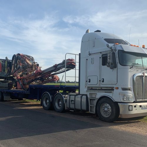 Heavy transport truck with machinery on board